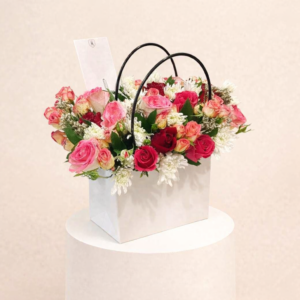 A Bouquet Of Colorful Flowers In A Stylish Bag.