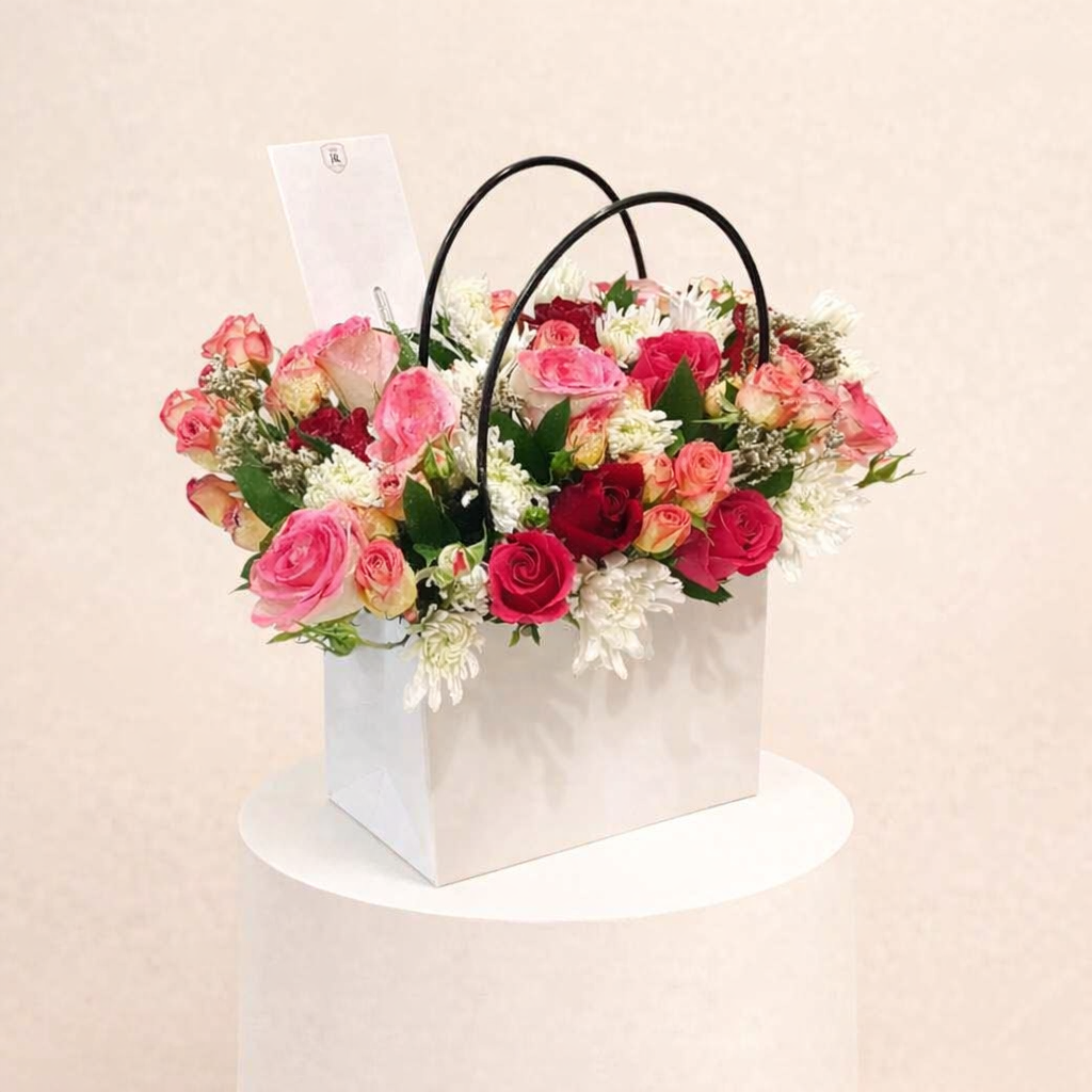 A Bouquet Of Colorful Flowers In A Stylish Bag. 1 A Bouquet Of Colorful Flowers In A Stylish Bag.